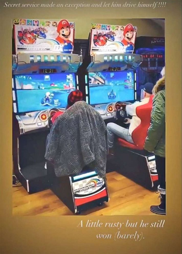 Naomi Biden shared an Instagram story on her account including a clip of her grandfather, at right, playing Mario Kart in what looks like a small arcade at Camp David. She captioned it “Secret service made the exception and let him drive himself.” 