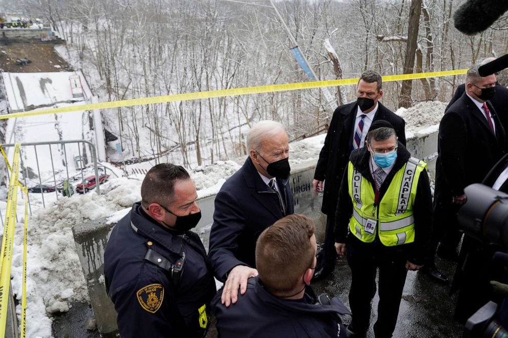 PHOTO: President Joe Biden talks first responders as he visits the site where the Fern Hollow Bridge collapsed, Jan. 28, 2022, in Pittsburgh's East End.
