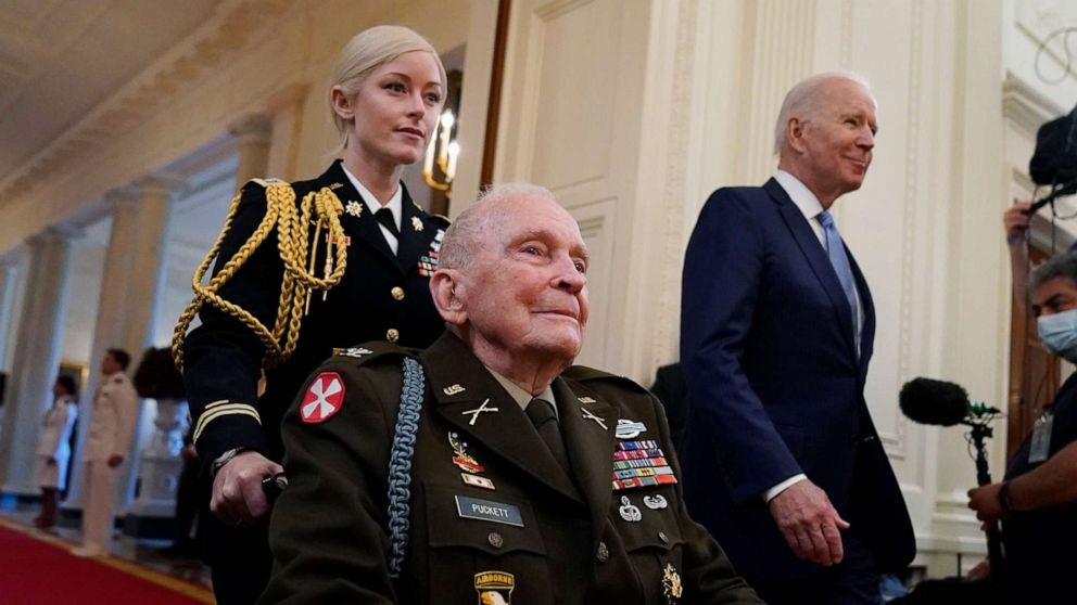 PHOTO: President Joe Biden arrives with retired U.S. Army Col. Ralph Puckett, who will be presented the Medal of Honor, in the East Room of the White House, May 21, 2021, in Washington.