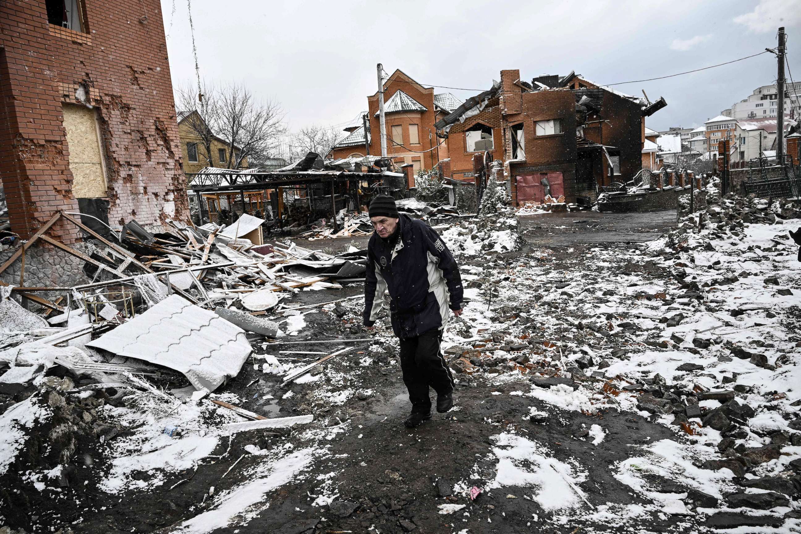 PHOTO: A man walks between houses destroyed during air strikes on the central Ukranian city of Bila Tserkva, March 8, 2022.