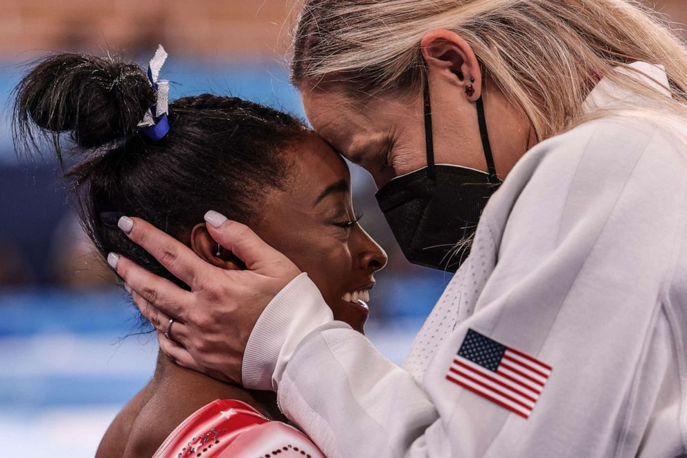 PHOTO: Simone Biles is congratulated by her coach Cecile Landi as it becomes evident she will earn a medal in the Women's Balance Beam Final at Ariake Gymnastics Centre on Aug. 3, 2021, in Tokyo, Japan.