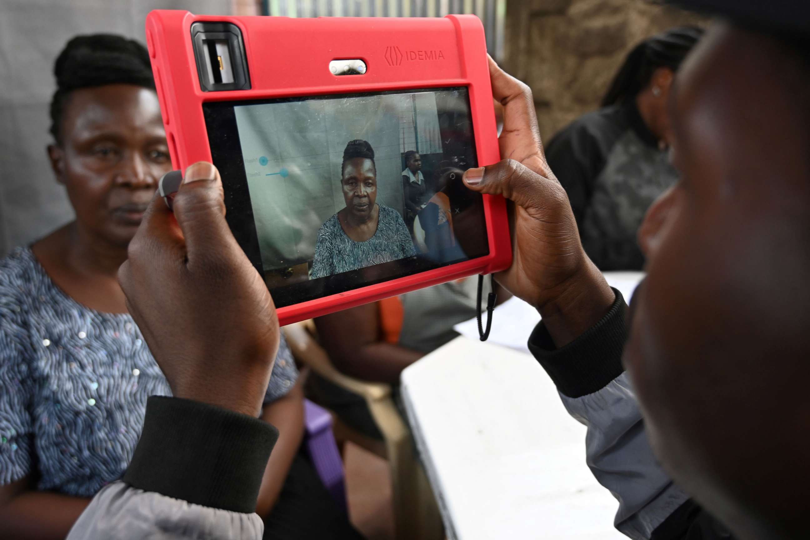 PHOTO: A Kenyan woman looks at a biometric camera prior to register for the Huduma Namba, May, 17, 2019, in Nairobi.