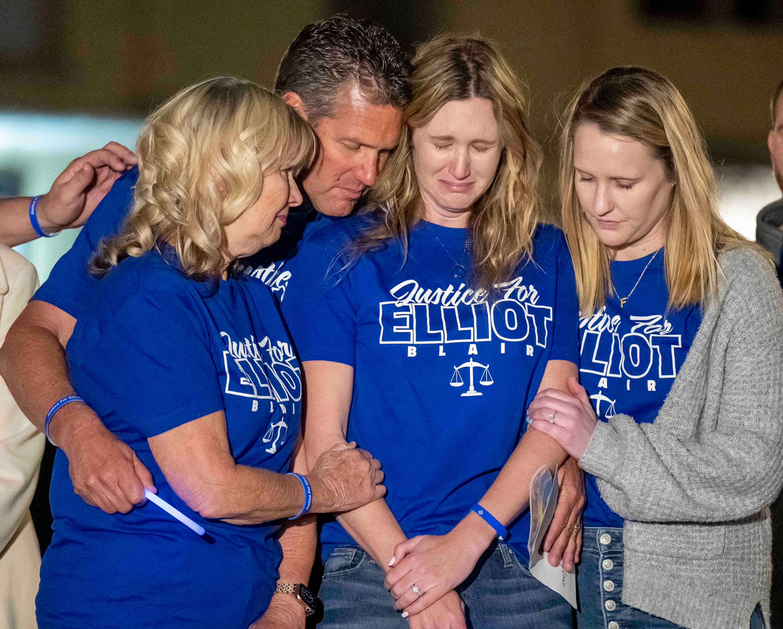 PHOTO: Kimberly Williams, second from right, the wife of Elliot Blair, is comforted by her family during a candlelight vigil in Orange, Calif., Jan 26, 2023, for Orange County deputy public defender Elliot Blair who died in Mexico.