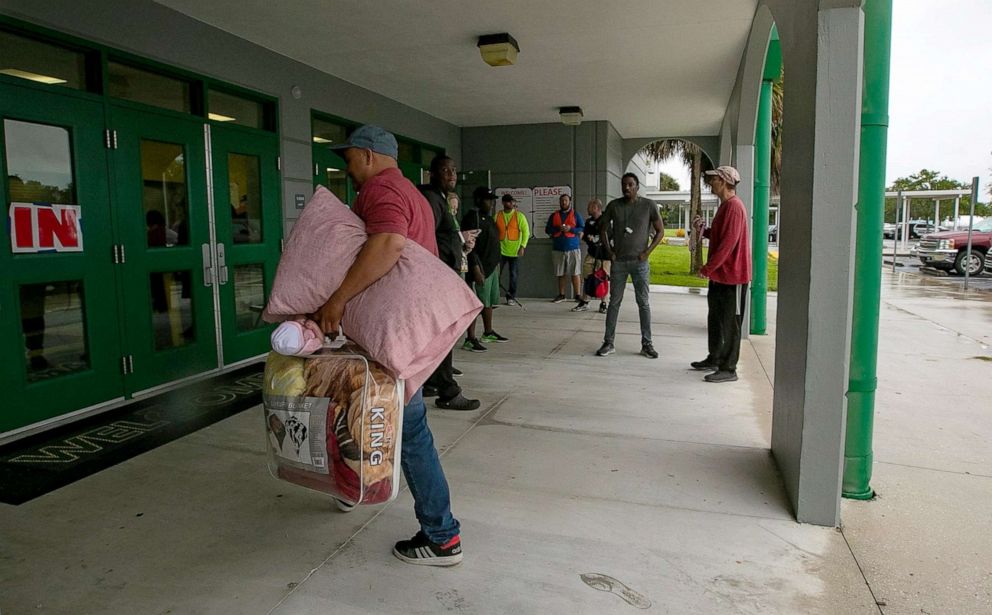 PHOTO: Cape Coral residents arrive at Island Coast High School for shelter after mandatory evacuations in areas of the city were implemented due to possible impact from Hurricane Ian in Fort Myers, Fla., Sept. 27, 2022