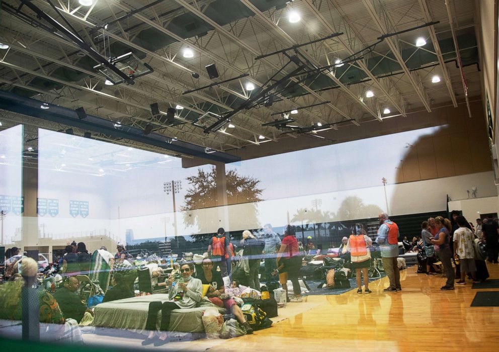 PHOTO: People get settled into the gym at Island Coast High School, the only shelter open ahead of the arrival of Hurricane Ian, in Cape Coral, Ft Myers, Fla., on the afternoon of Sept. 27, 2022.