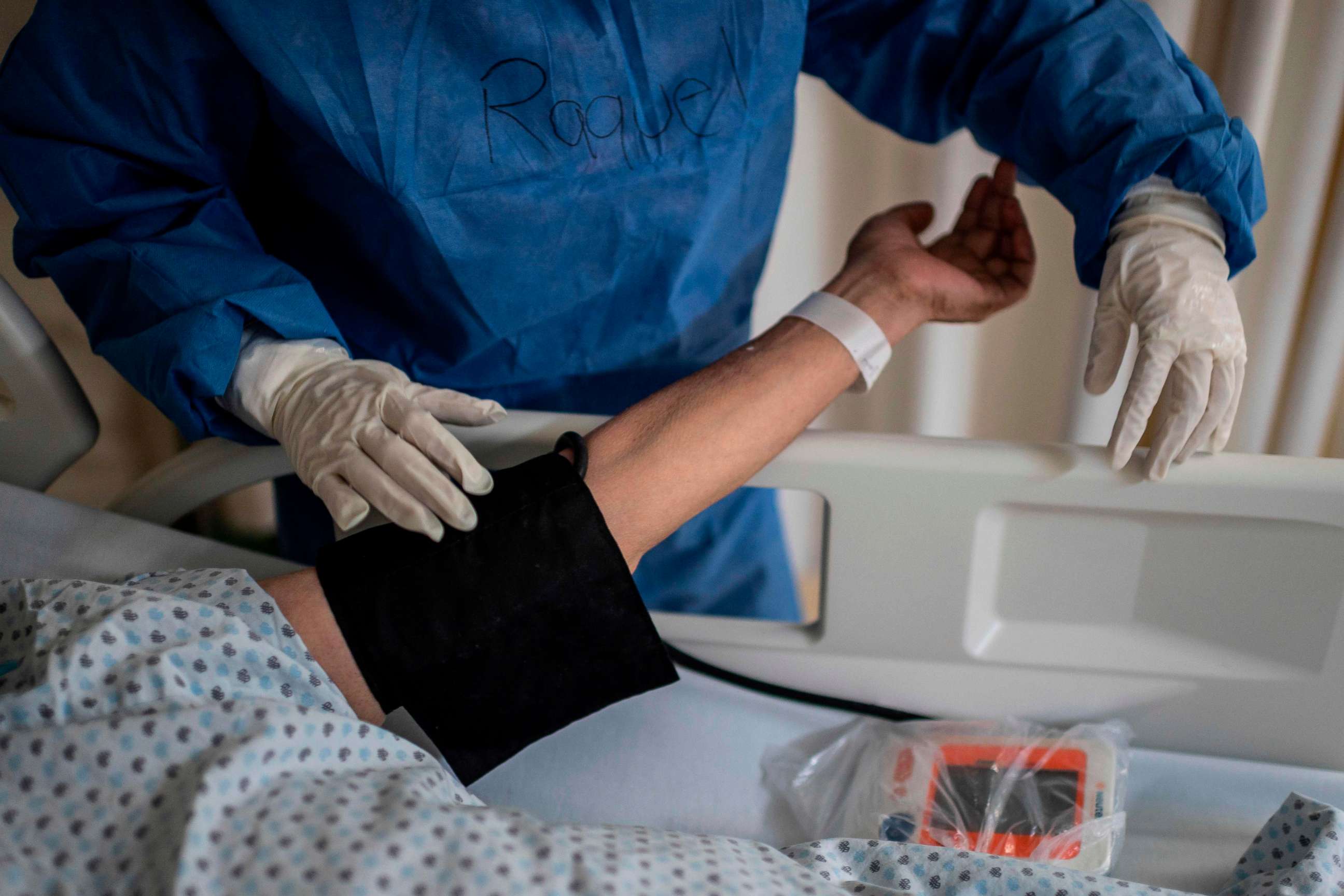 PHOTO: A health worker measures the blood pressure of a patient at the COVID-19 zone of a hospital in Atizapan, Mexico, on May 22, 2020, amid the new coronavirus pandemic. 