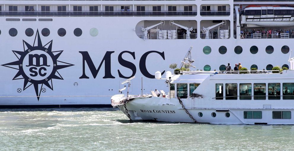 PHOTO:A tourist river boat, left, is dwarfed by the MSC Magnifica cruise ship passing by, in Venice, Italy, June 2, 2019. 