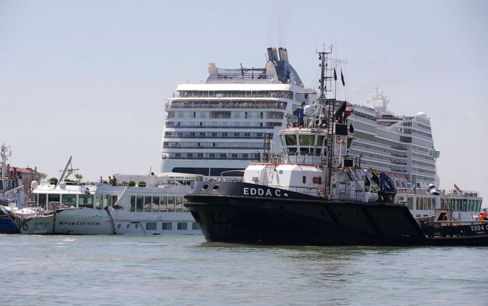 PHOTO:A tourist river boat, left, is dwarfed by the MSC Magnifica cruise ship passing by, in Venice, Italy, June 2, 2019. 