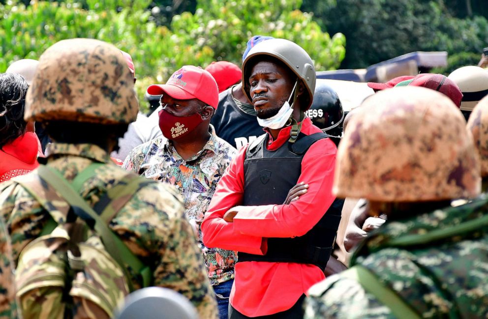 PHOTO: Ugandan presidential candidate Robert Kyagulanyi, also known as Bobi Wine, is escorted by police during his arrest in Kalangala in central Uganda on Dec. 30, 2020.