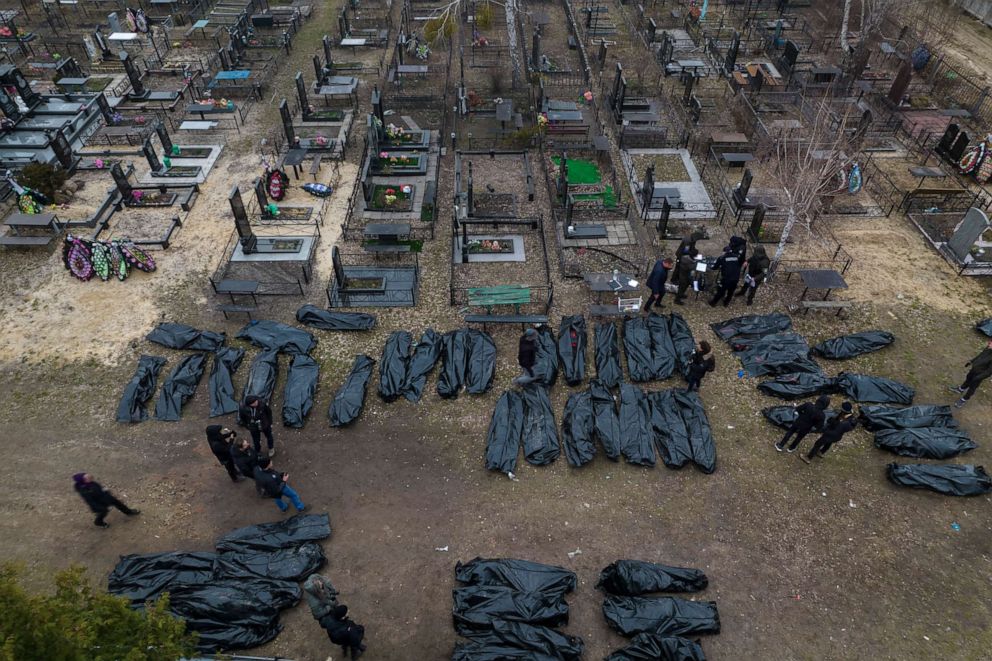 PHOTO: Police officers work on identifying bodies of civilians, before sending them to the morgue, in Bucha, northwest of Kyiv, Ukraine, on April 6, 2022.