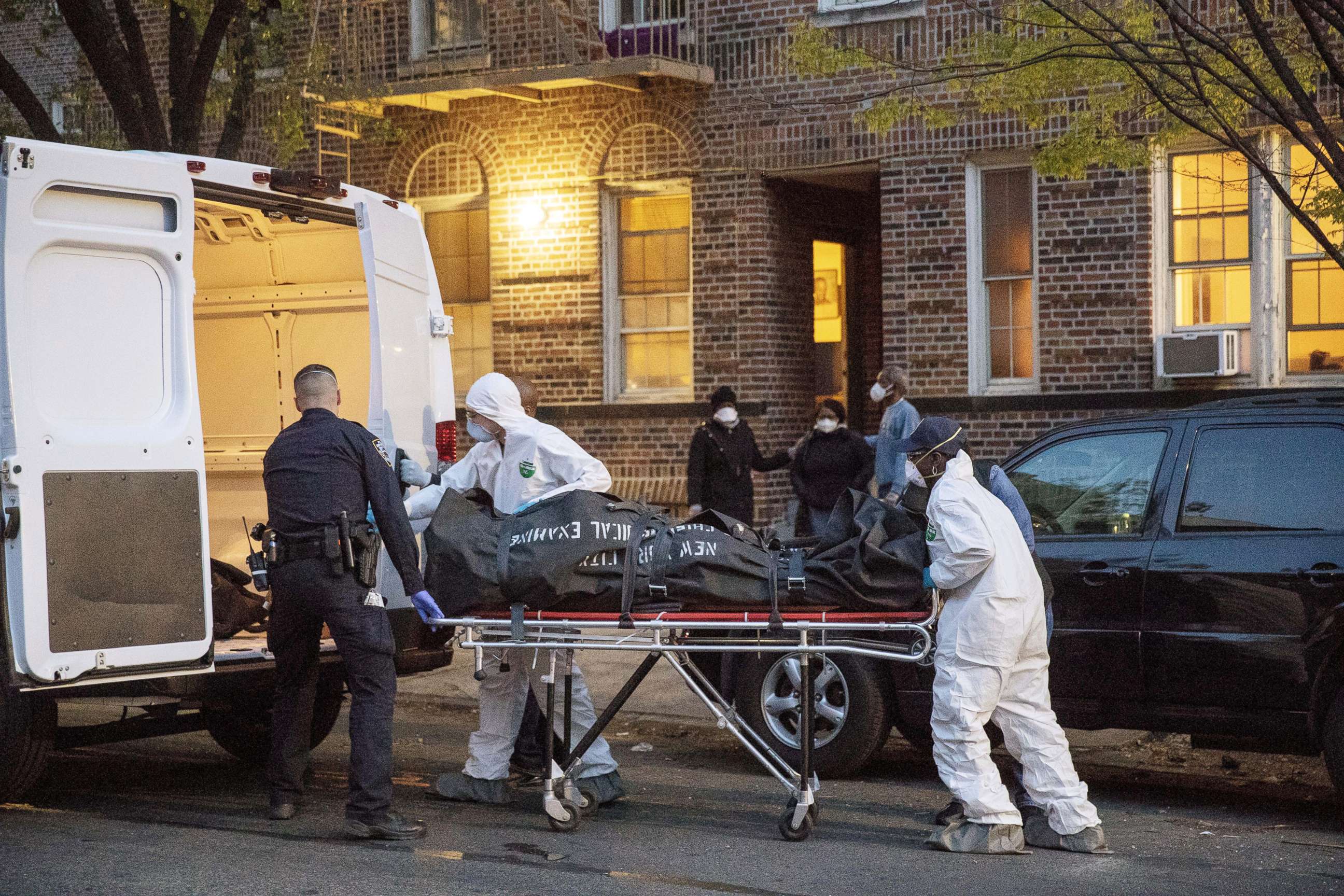 PHOTO: An officer from the New York Police Department helps workers carry a body out of a house amid the coronavirus disease (COVID-19) outbreak, in the Brooklyn borough of New York City, April 20, 2020.