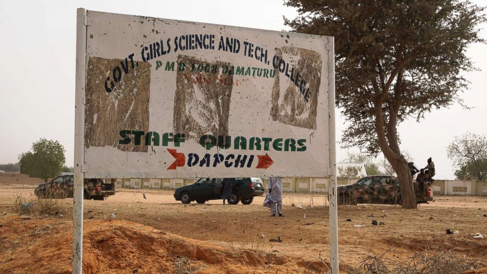 PHOTO: Soldiers (R) drive past a signpost leading to the Government Girls Science and Technical College staff quarters in Dapchi, Nigeria, Feb. 22, 2018.  