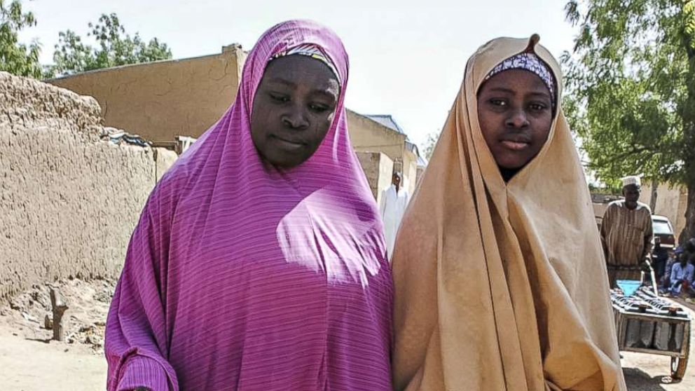 PHOTO: A girl, right, released by Boko Haram walks with her mother in Dapchi, Nigeria on March 21, 2018, after Boko Haram Islamists who kidnapped 110 schoolgirls  just over a month ago returned 101 of the students to the town, the government said. 