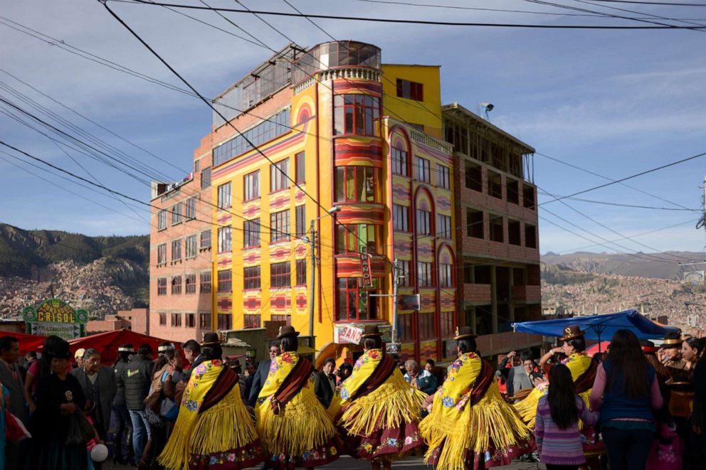 PHOTO: Members of a morenada fraternity perform in front of a colourful events salon, locally known as "cholet", during the Gran Poder Fiesta in La Paz, Bolivia May 14, 2017.
