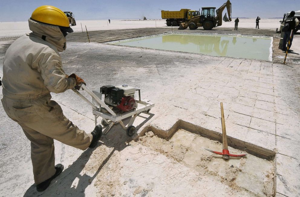 PHOTO: A work cuts salt bricks from Uyuni - the largest salt flats in the world, at the state-run Lithium Pilot Plant in Rio Grande, Bolivia, Oct. 29, 2009.