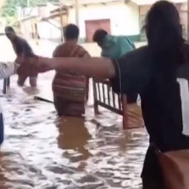 Bolivians struggle to save possessions and get to safety after rivers burst their banks, flooding thousands of family homes across the country.