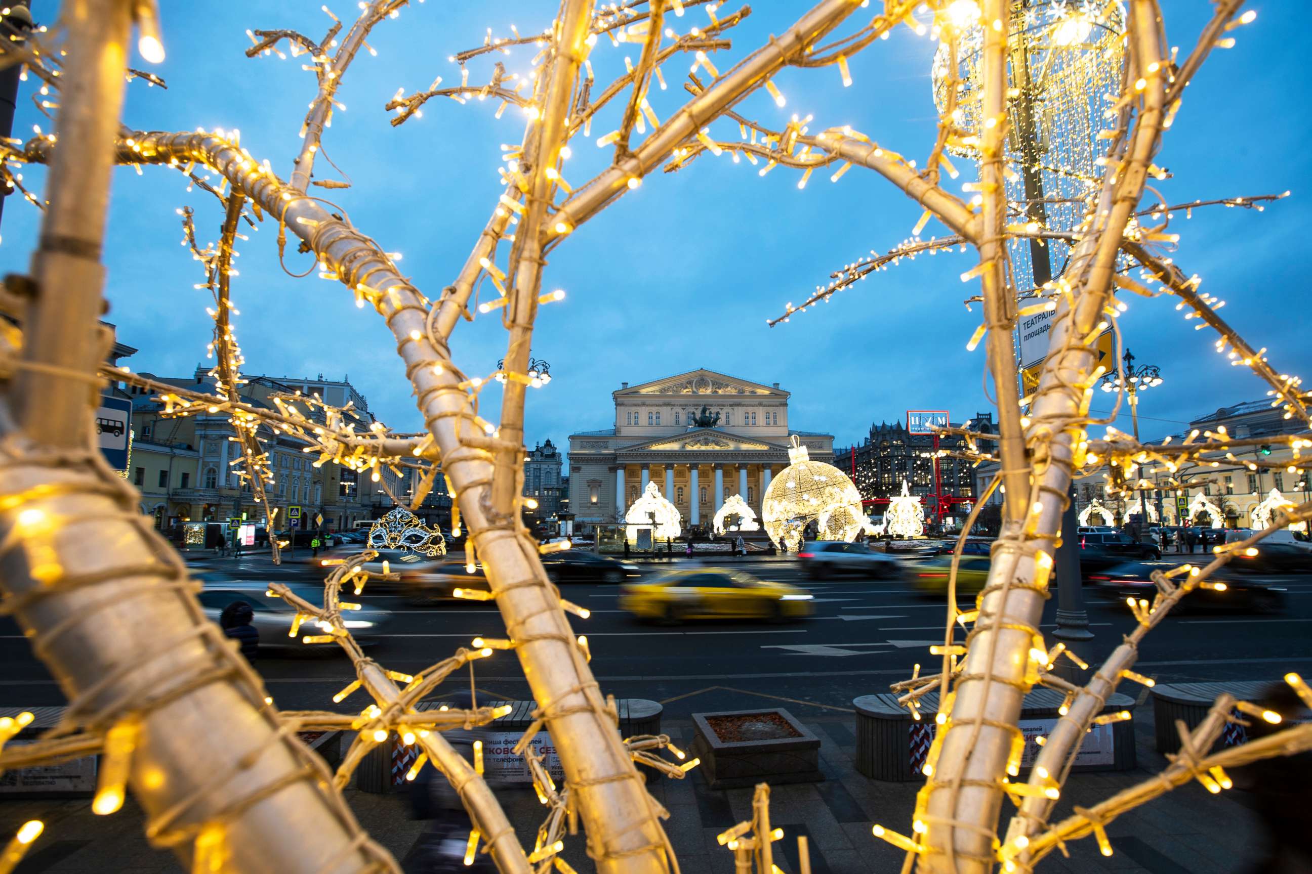 PHOTO: Cars pass the Bolshoi Theatre amid holiday decorations in Moscow, Dec. 21, 2020.