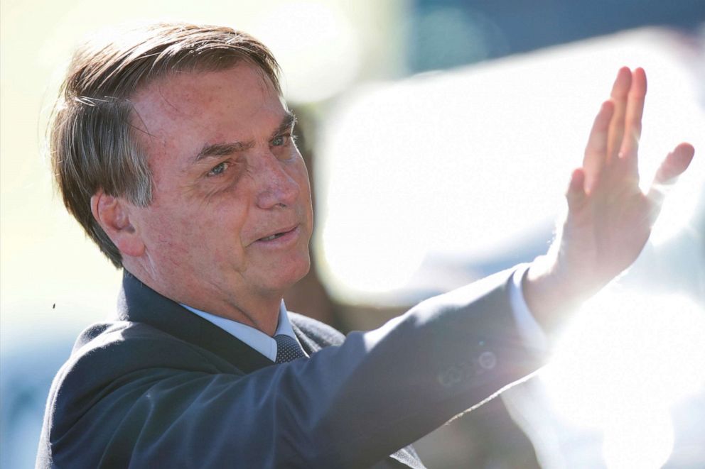 PHOTO: Brazil's President Jair Bolsonaro gestures while meeting supporters as he leaves at Alvorada Palace, amid coronavirus disease (COVID-19) outbreak, in Brasilia, Brazil, April 1, 2020. 