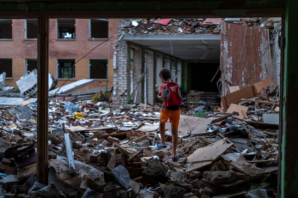 PHOTO: FILE - Ivan Hubenko, 11, walks on the rubble of his former Chernihiv School #21, which was bombed by Russian forces on March 3, in Chernihiv, Ukraine, Tuesday, Aug. 30, 2022.