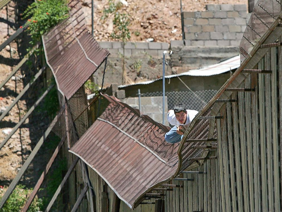 PHOTO: In this May 31, 2006, file photo, a man climbs over the international border into Nogales, Ariz., from Nogales, Mexico.