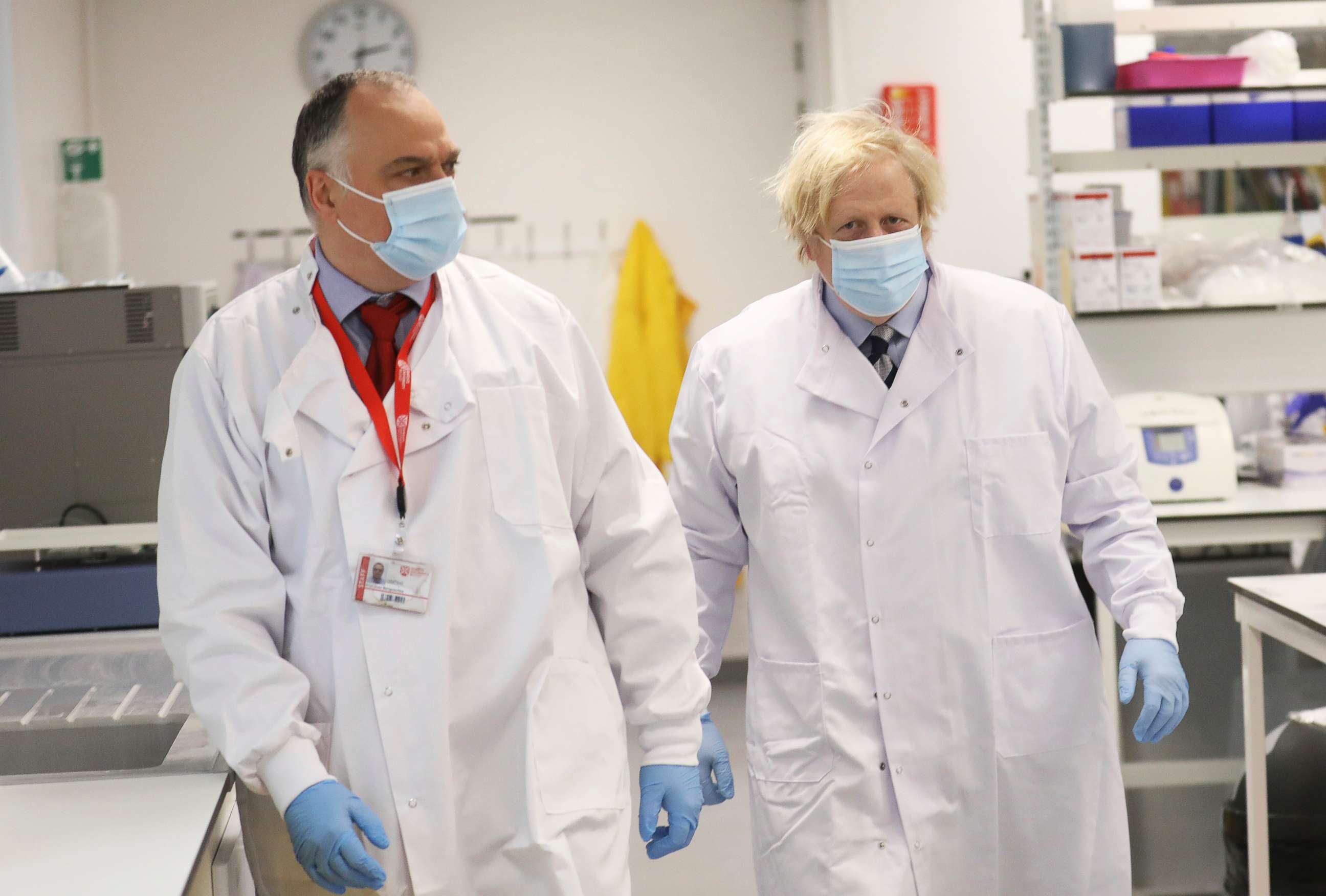 PHOTO: British Prime Minister Boris Johnson meets with Professor Jose Bengoechea, left, during a visit at the Wellcome-Wolfson Institute For Experimental Medicine, Queen's University on March 12, 2021 in Belfast, Northern Ireland.