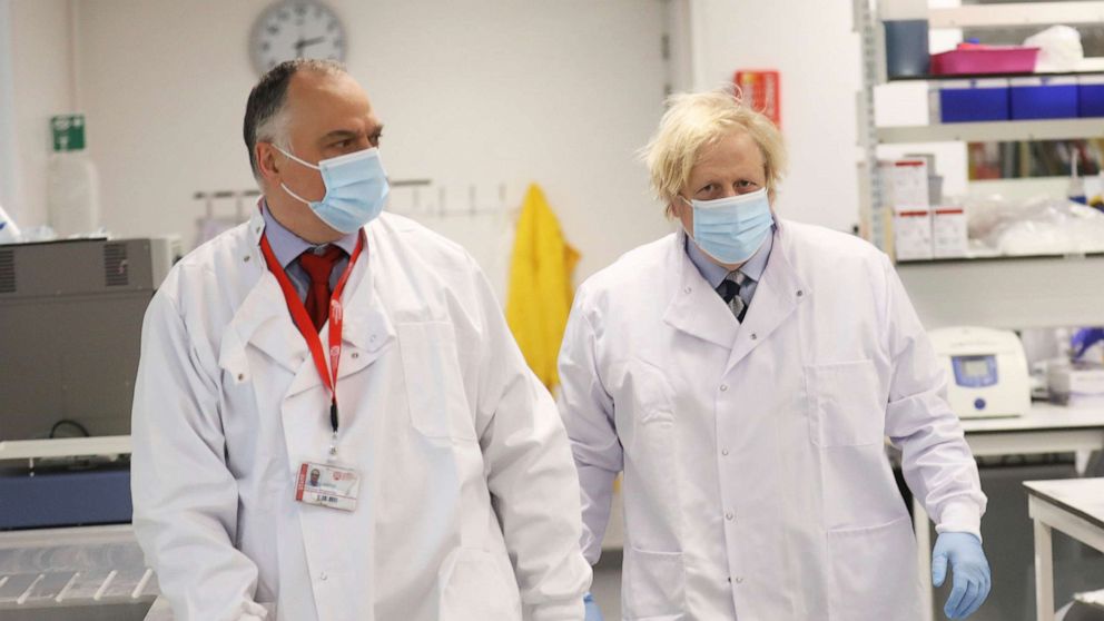 PHOTO: British Prime Minister Boris Johnson meets with Professor Jose Bengoechea, left, during a visit at the Wellcome-Wolfson Institute For Experimental Medicine, Queen's University on March 12, 2021 in Belfast, Northern Ireland.