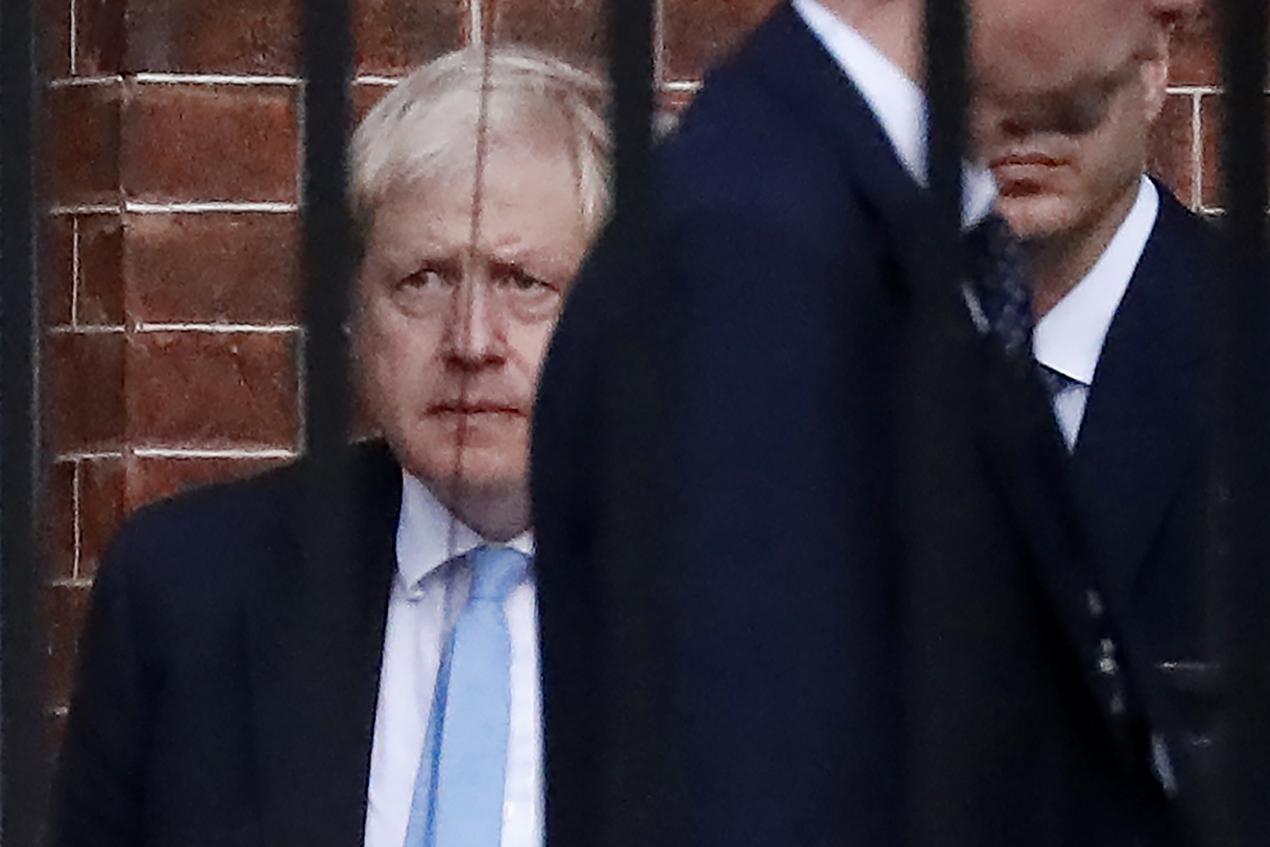 PHOTO: Britain's Prime Minister Boris Johnson (L) leaves from the rear of 10 Downing Street in central London on October 16, 2019.