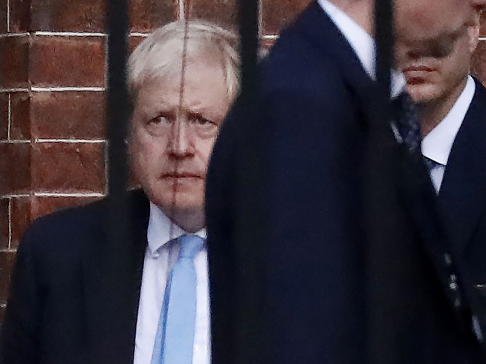 PHOTO: Britains Prime Minister Boris Johnson (L) leaves from the rear of 10 Downing Street in central London on October 16, 2019.