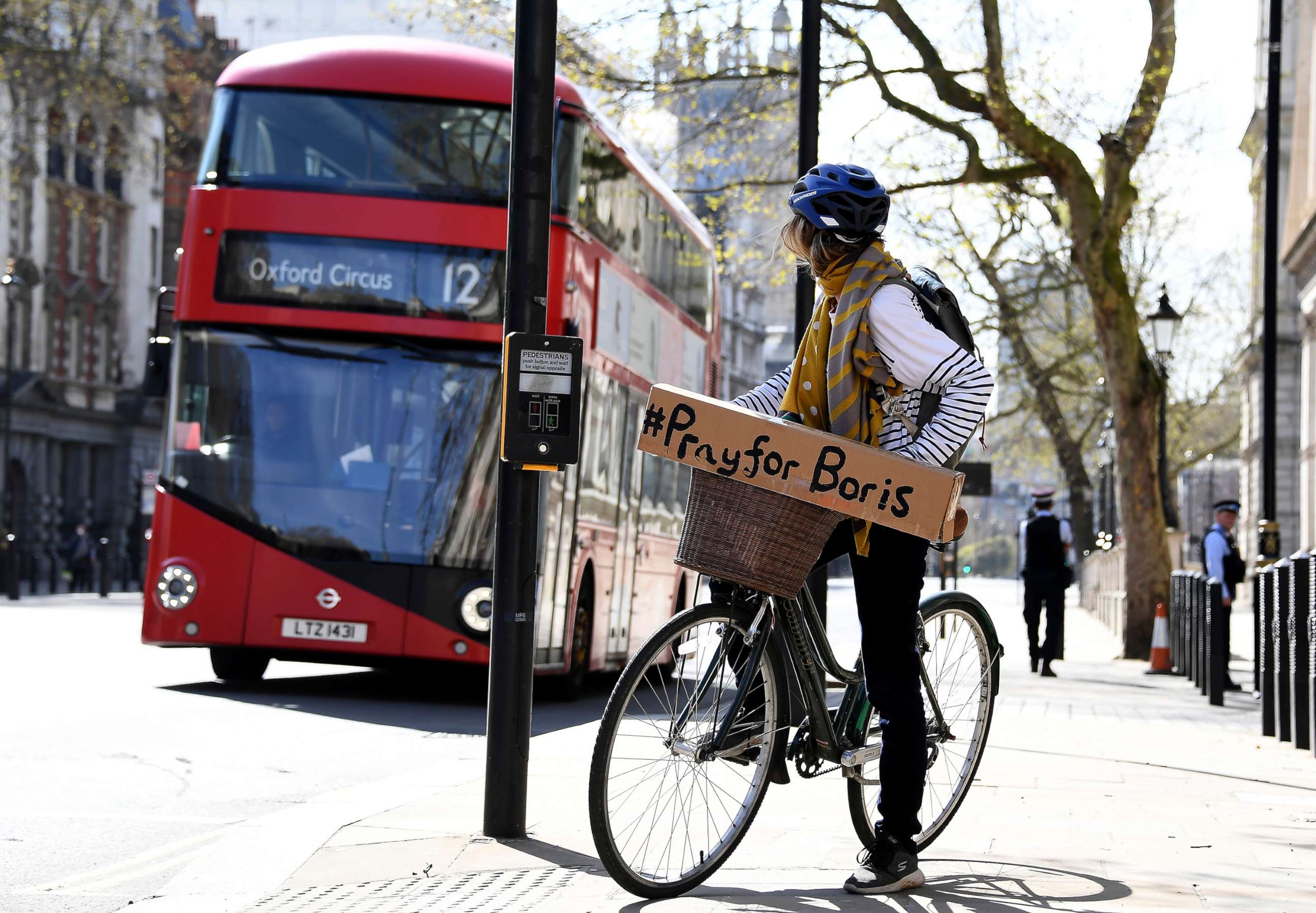 PHOTO: A woman carries a sign in support of British Prime Minister Boris Johnson who is in intensive care fighting the coronavirus in London, April 7, 2020.