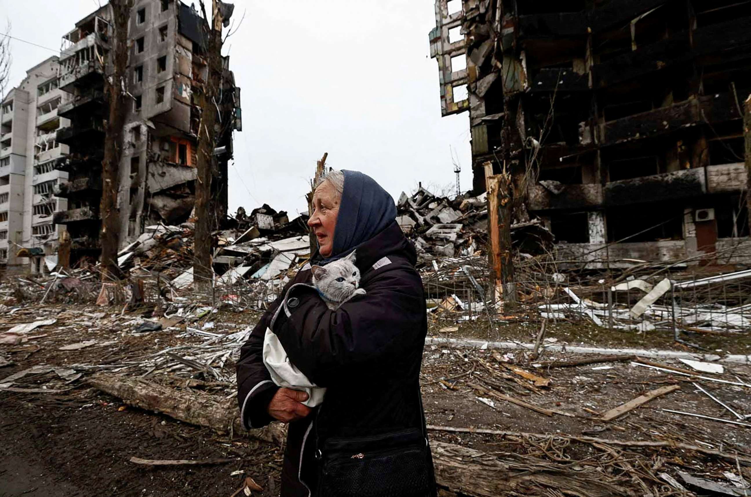 PHOTO: A woman carries her cat as she walks past buildings that were destroyed by Russian shelling, in Borodyanka, in the Kyiv region, Ukraine, April 5, 2022.