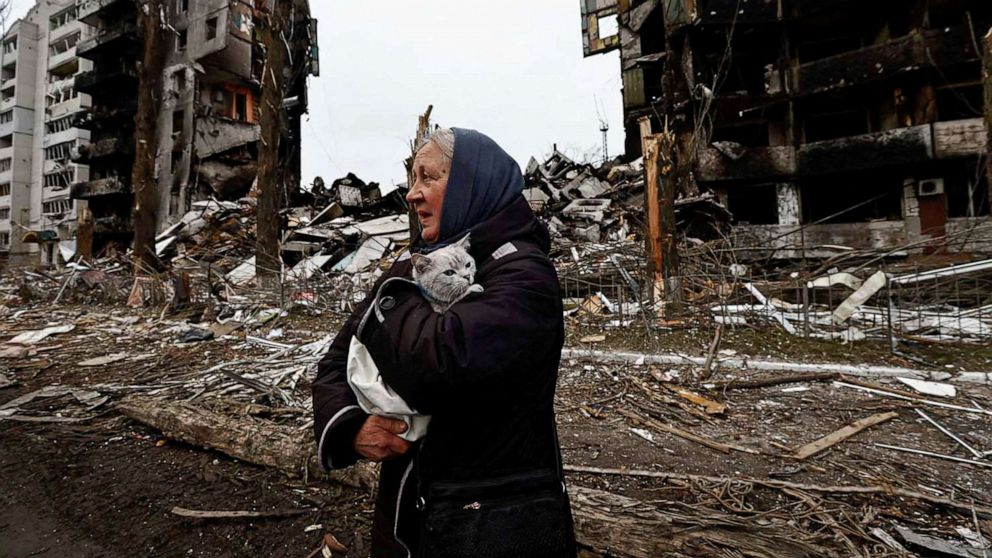 PHOTO: A woman carries her cat as she walks past buildings that were destroyed by Russian shelling, in Borodyanka, in the Kyiv region, Ukraine, April 5, 2022.