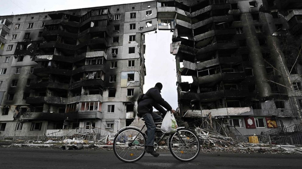 PHOTO: A cyclist passes by a destroyed building in the town of Borodianka, northwest of Kyiv, on April 6, 2022.