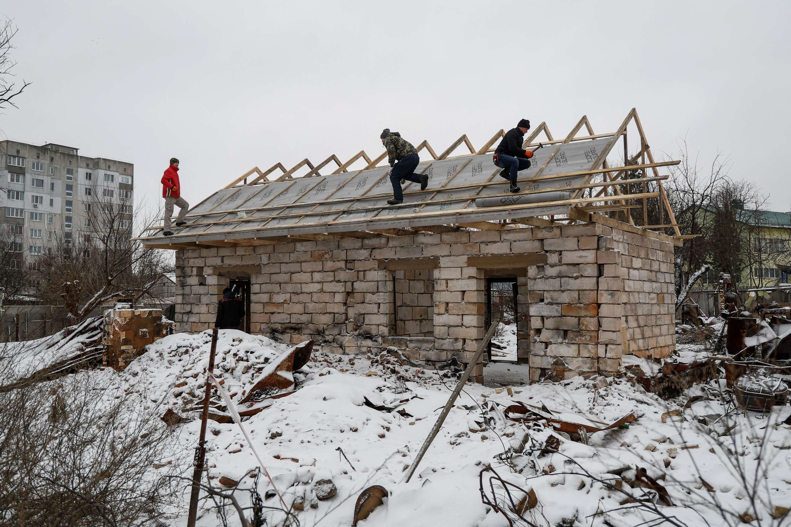 PHOTO: Workers repair a roof of a house heavily damaged in the beginning of Russia's attack on Ukraine, in the town of Borodyanka, Kyiv region, Ukraine, Dec. 15, 2022.