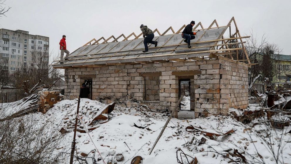 PHOTO: Workers repair a roof of a house heavily damaged in the beginning of Russia's attack on Ukraine, in the town of Borodyanka, Kyiv region, Ukraine, Dec. 15, 2022.