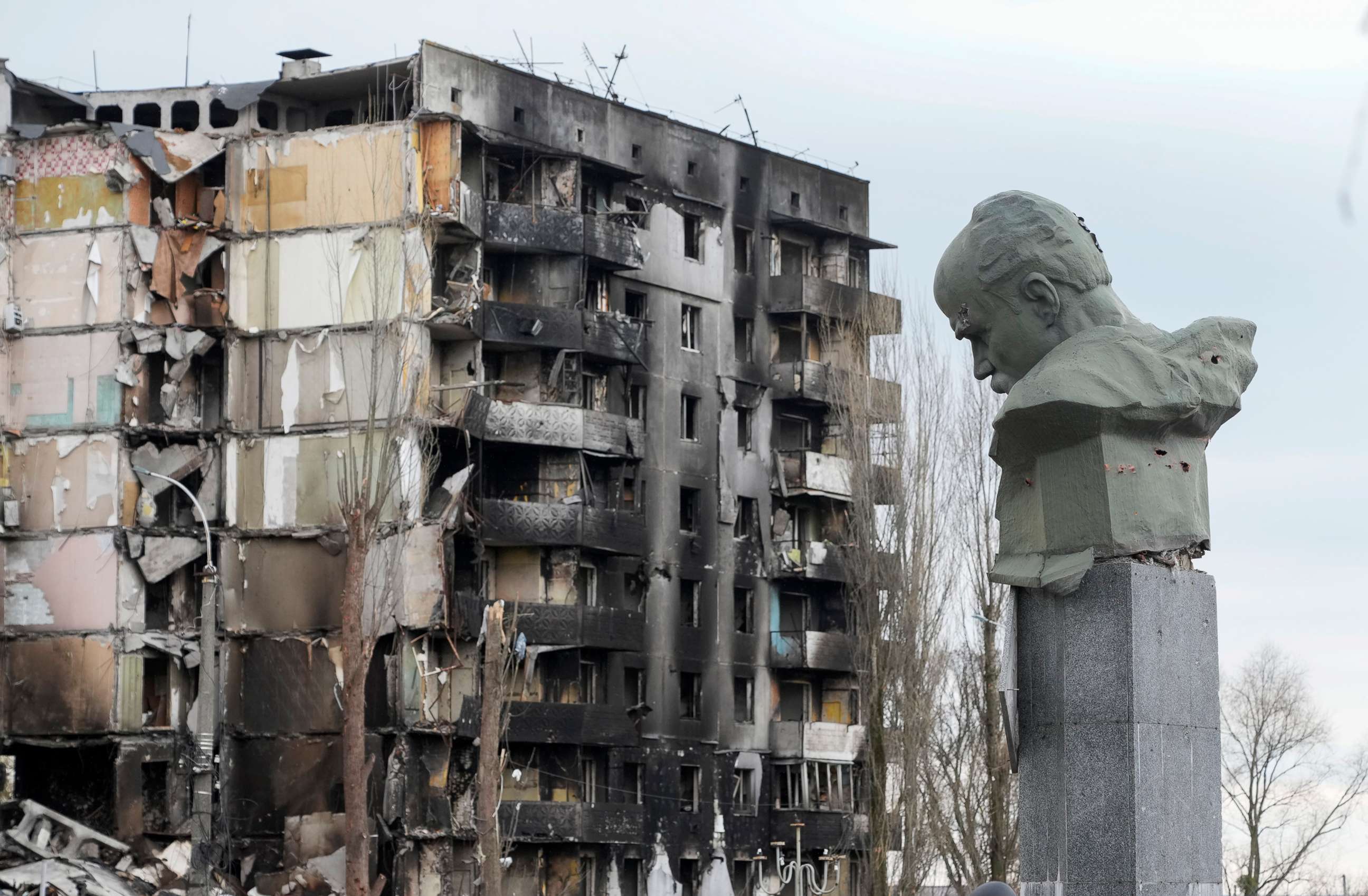 PHOTO: A monument to Taras Shevchenko, a Ukrainian poet and a national symbol, showing damage from bullets, stands against the background of an apartment house ruined in the Russian shelling in the central square in Borodyanka, Ukraine, April 6, 2022.