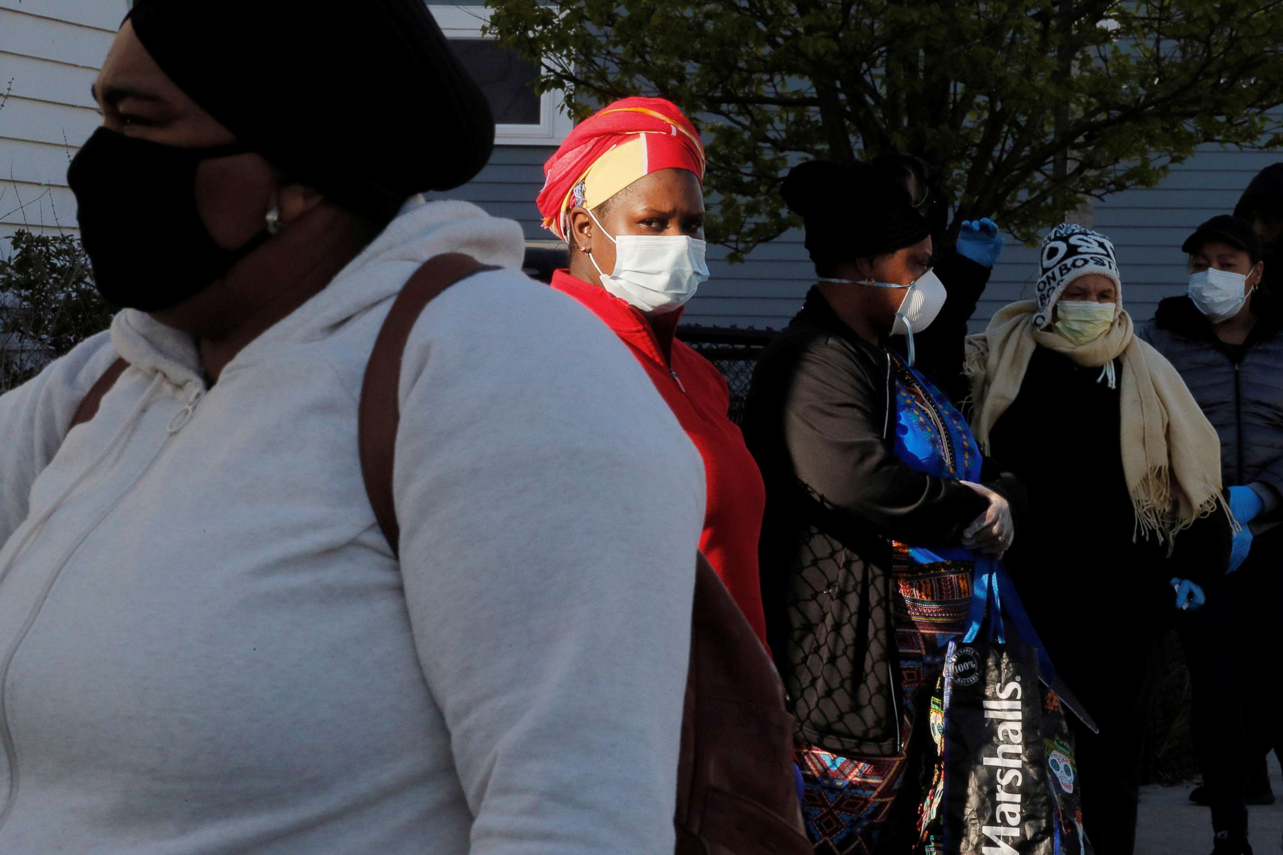 PHOTO: People wait in line to pick up groceries from the food pantry at the Fourth Presbyterian Church amid the coronavirus disease (COVID-19) outbreak in Boston, April 14, 2020.