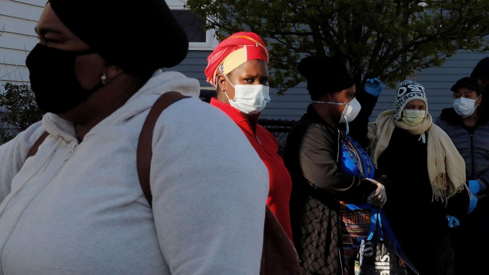 PHOTO: People wait in line to pick up groceries from the food pantry at the Fourth Presbyterian Church amid the coronavirus disease (COVID-19) outbreak in Boston, April 14, 2020.