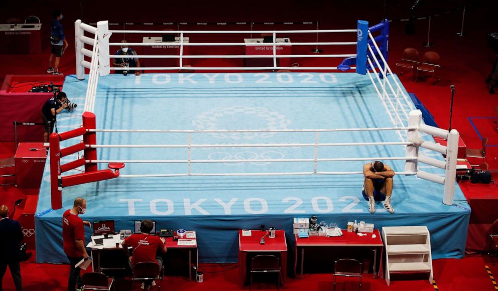 PHOTO: Mourad Aliev of France sits outside the ring in protest after losing his match against Frazer Clarke of Great Britain in the Men's Super Heavy (+91kg) quarterfinal match of the Boxing events of the Tokyo 2020 Olympic Games in Tokyo.