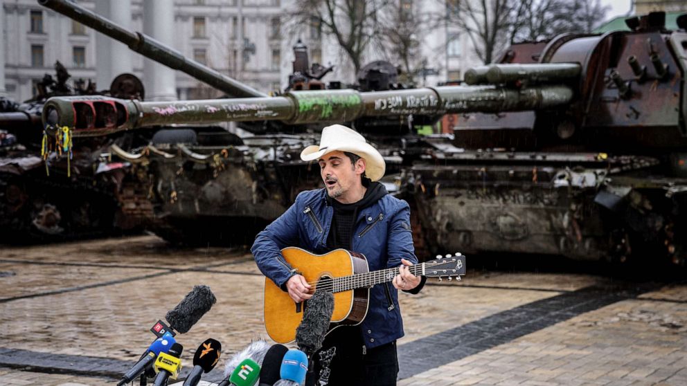 PHOTO: Brad Paisley performs in front of destroyed Russian military equipment at the Mikhailovsky Square in Kyiv on April 12, 2023, amid the Russian invasion of Ukraine.