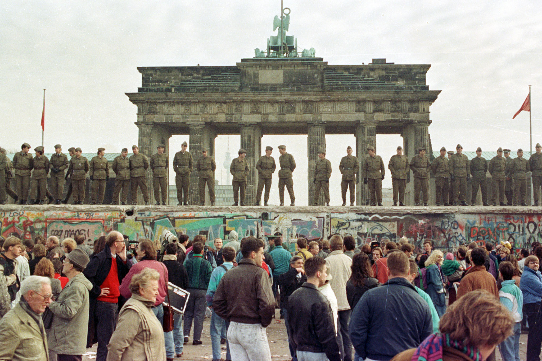 PHOTO: In this file photo, East Berlin border guards stand atop the Berlin Wall in front of the Brandenburg Gate, Nov. 11, 1989.