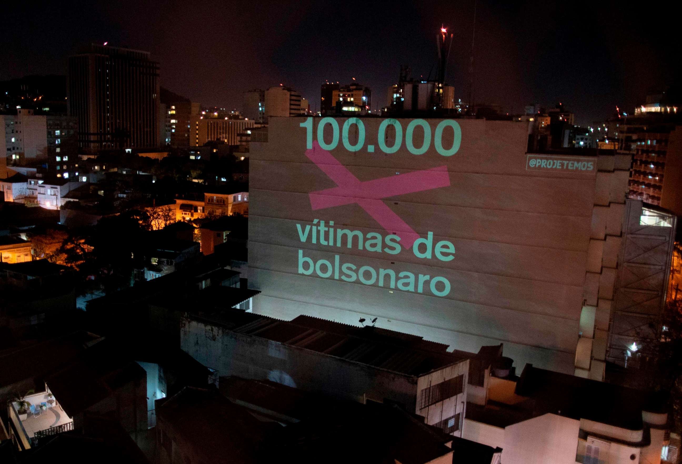PHOTO: A projection on a building honoring the 100,000 victims who died of COVID-19 in Brazil reads "100,000 Victims of (Brazilian President Jair) Bolsonaro" as the country became the second to pass the milestone, in Rio de Janeiro on Aug. 8, 2020.