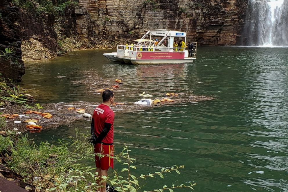 PHOTO: Firefighters at the scene of a rescue operation after a wall of rock broke from a cliff falling onto several tourist boats at the canyons of Furnas Lake, city of Capitolio, Minas Gerais State, Brazil, Jan. 8, 2022. 