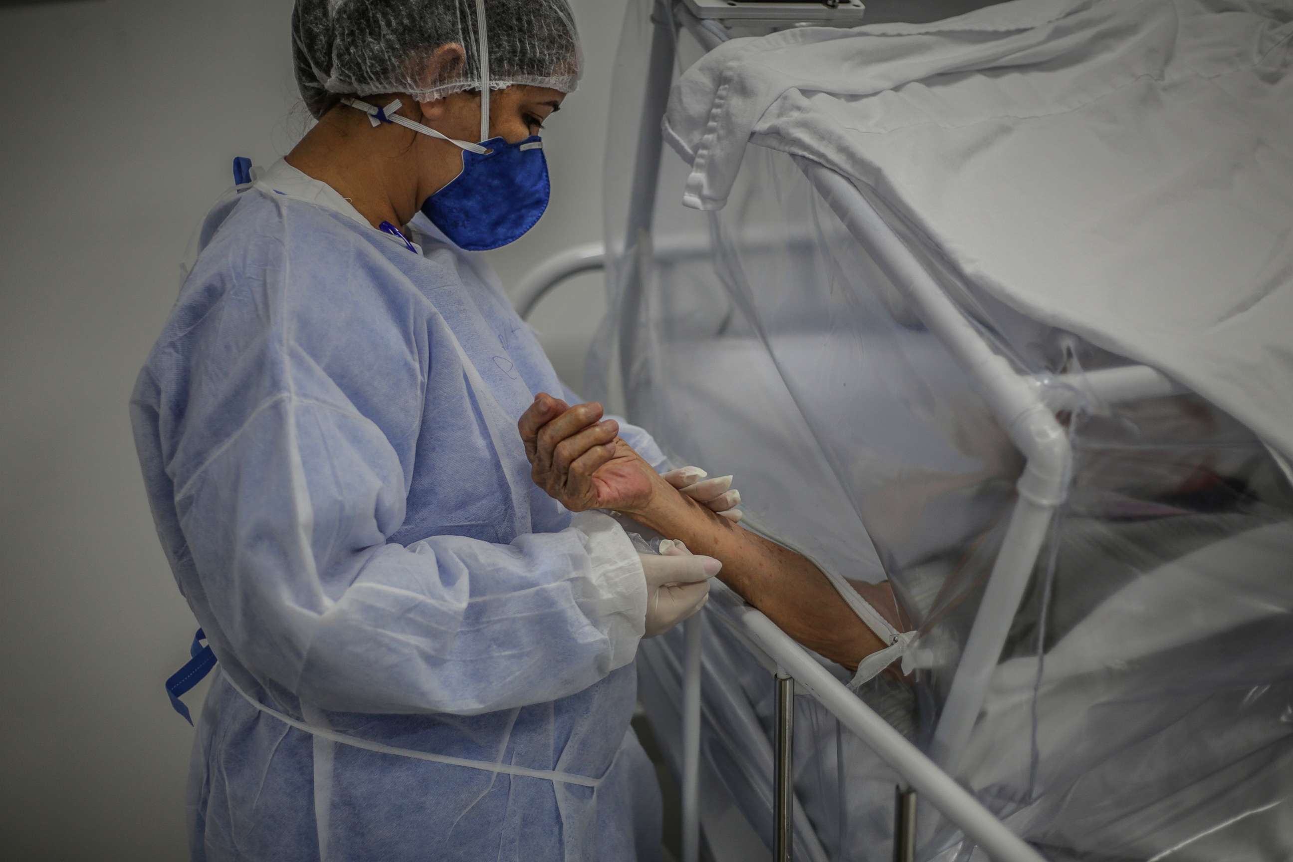 PHOTO: A nurse holds the arm of a patient infected by COVID-19 at the Gilberto Novaes Municipal Field Hospital, on May 21 2020, in Manaus, Brazil.