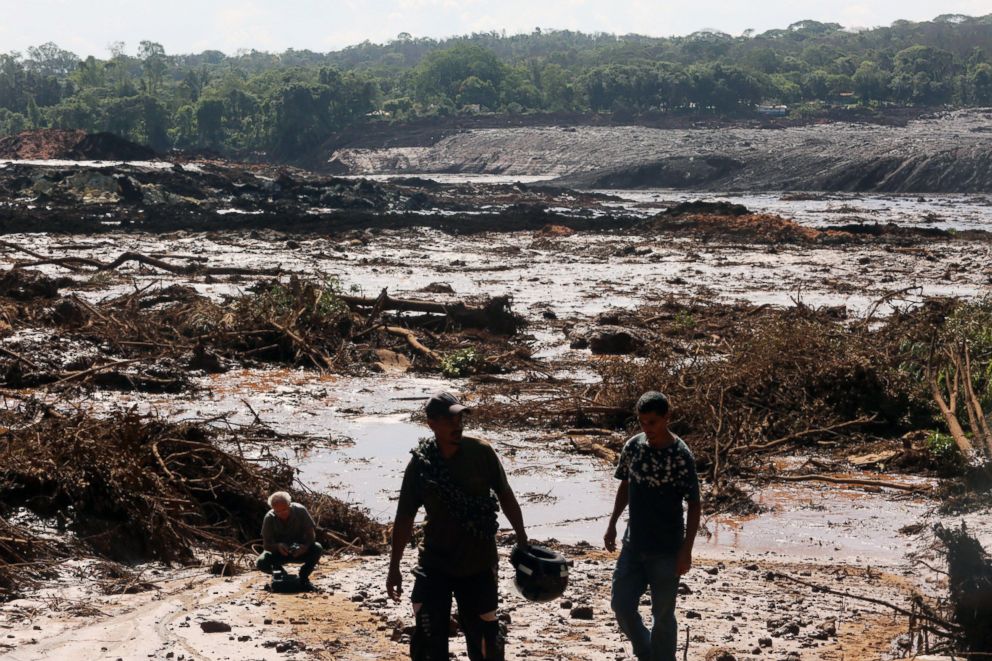 PHOTO: Men walk near damage caused by the breakage of a dam containing mineral waste from Vale, the world's largest iron producer, in Brumadinho, municipality of Minas Gerais, Brazil, Jan. 25, 2019.