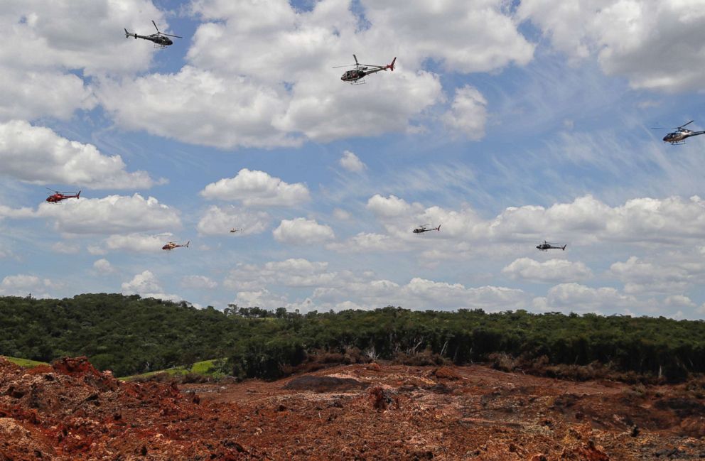  Helicopters hover over an iron ore mining complex to release thousands of flower petals paying homage to the 110 victims confirmed killed and 238 who are still missing after a mining dam collapsed there a week ago, in Brumadinho, Brazil, Feb. 1, 2019. 
       