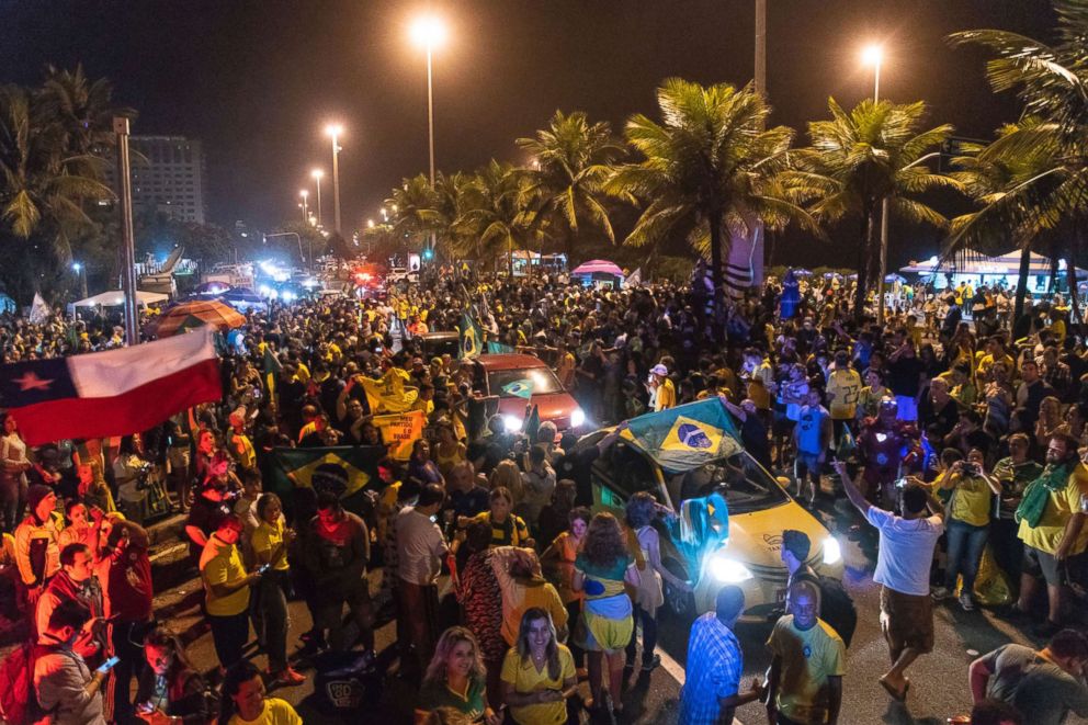 PHOTO: Supporters of Jair Bolsonaro, presidential candidate with the Social Liberal Party celebrate in front of his house in Rio de Janeiro, Oct. 7, 2018.