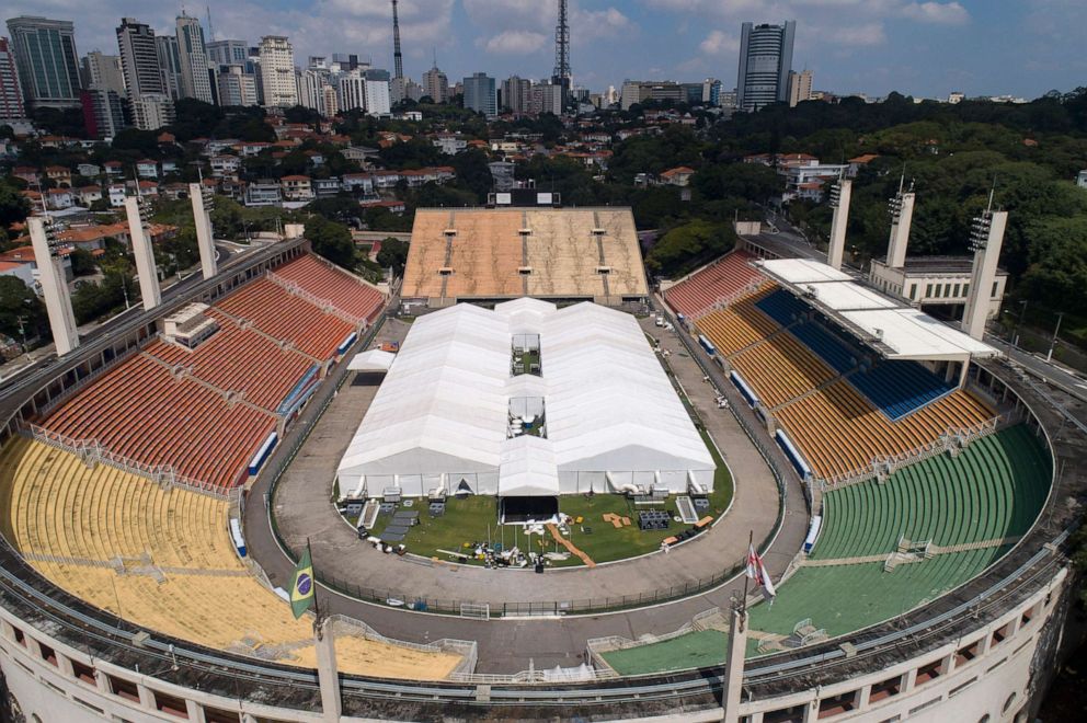 PHOTO: Workers set up a temporary field hospital to treat patients who have COVID-19 inside Pacaembu stadium in Sao Paulo, Brazil, March 30, 2020.