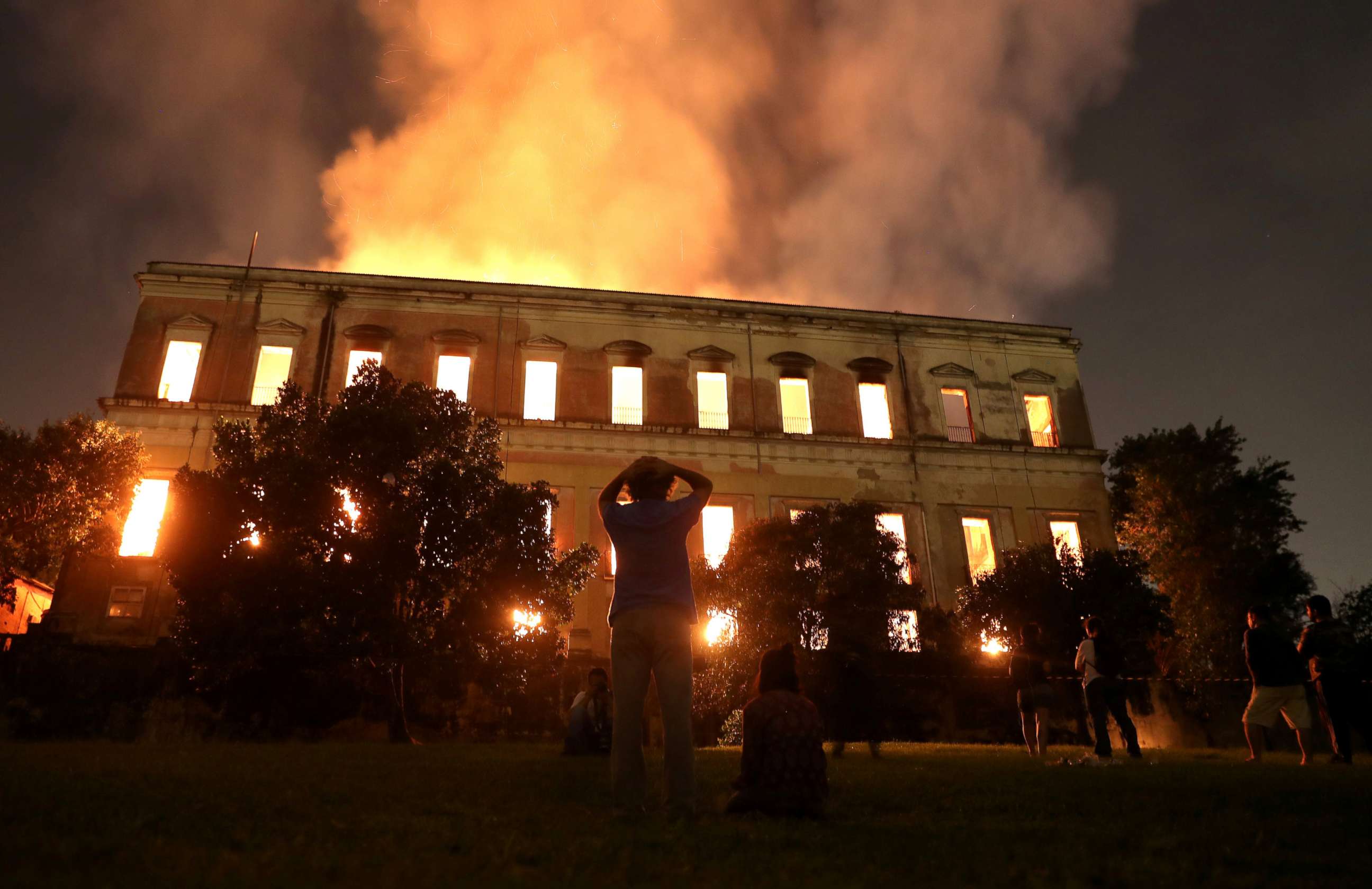 PHOTO: People watch as a fire burns at the National Museum of Brazil in Rio de Janeiro, Sept. 2, 2018.