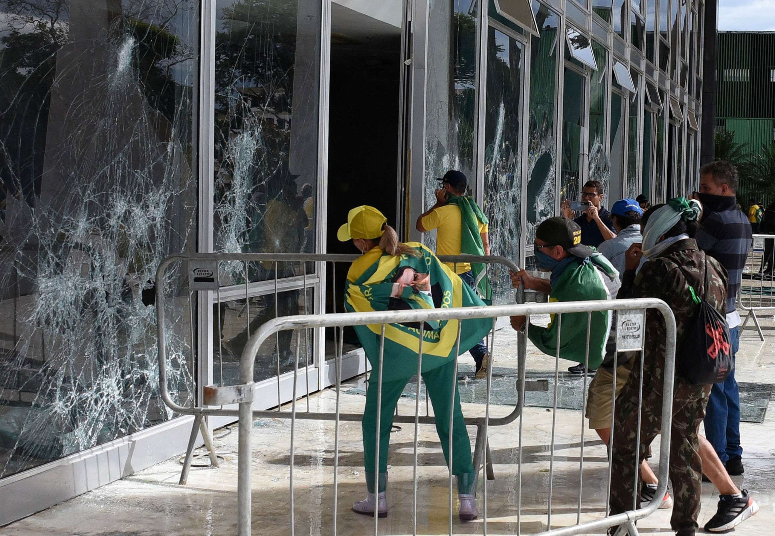 PHOTO: Supporters of Brazilian former President Jair Bolsonaro destroy a window of the the plenary of the Supreme Court in Brasilia, Jan. 8, 2023.