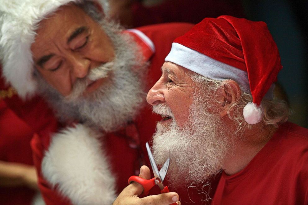 PHOTO: Saymon Claus, a student of Brazil's Santa Claus school, has his beard trimmed to mark the end of the season during an annual event called "Barbas de Molho" at a restaurant in Rio de Janeiro, Dec. 26, 2018.